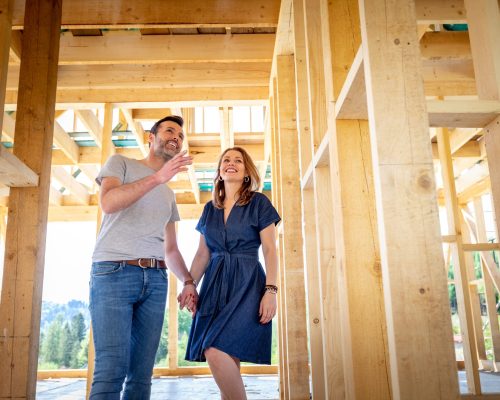 Couple walking in to a framed house