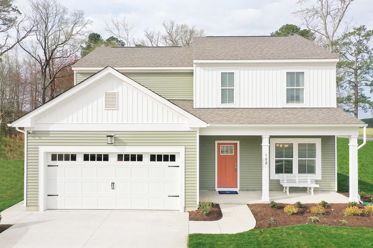 Village Pointe Home_ front view. Green and white exterior, 2 stories and two car garage